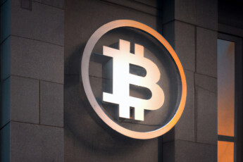 3D Bitcoin logo on wall